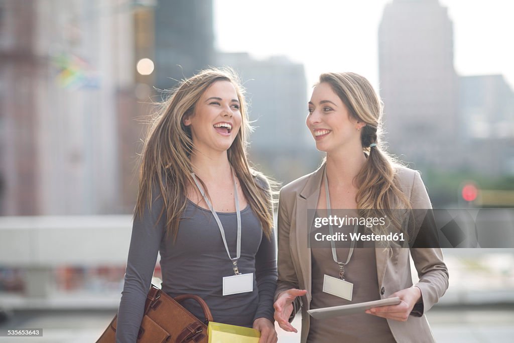 Two laughing businesswomen