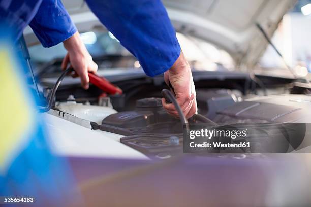 car mechanic at work in repair garage - car battery stock pictures, royalty-free photos & images