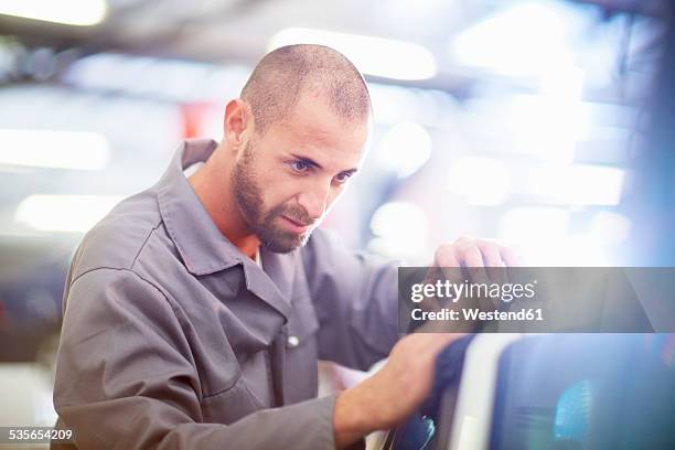 car mechanic at work in repair garage - karosseriarbete bildbanksfoton och bilder