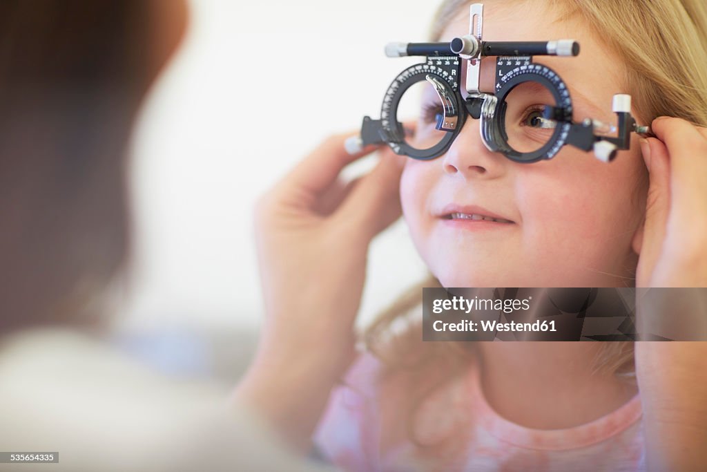 Eye doctor examining girl's vision