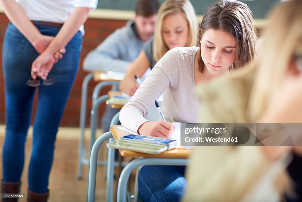 Students in classroom having an exam