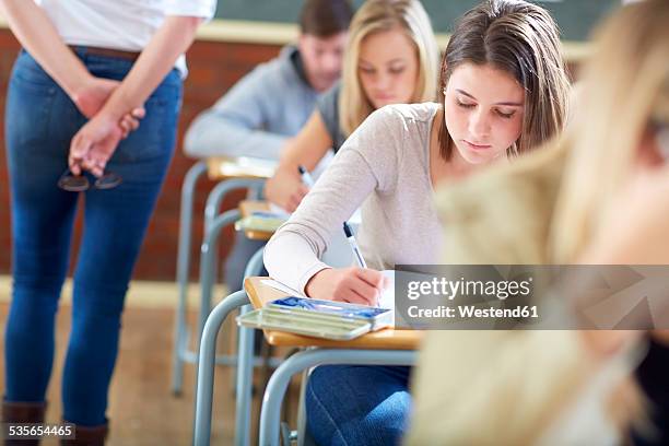 students in classroom having an exam - gymnasieexamen bildbanksfoton och bilder