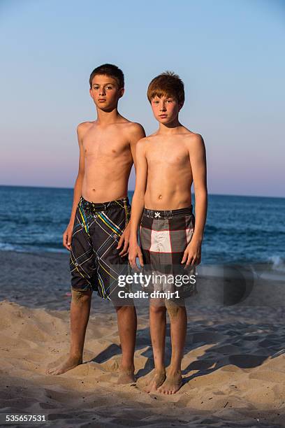 Two Boys Standing On Beach At Sunset High-Res Stock Photo - Getty