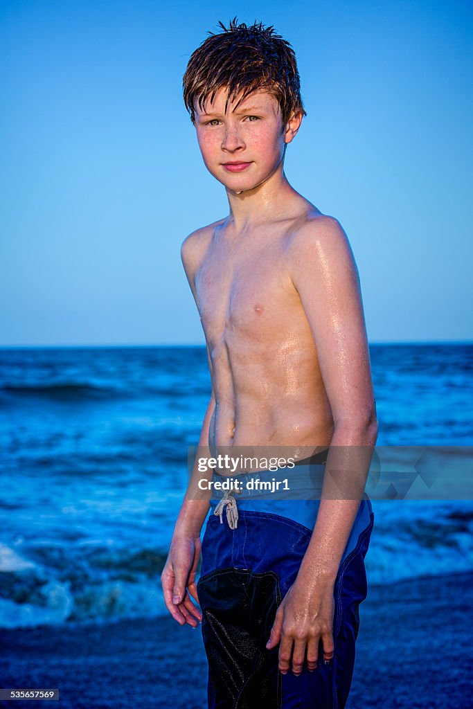 Portrait of a redhead boy standing on beach