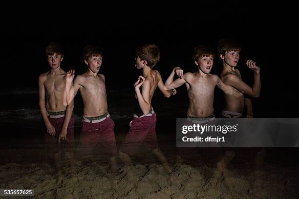 stroboscopic image of a boy dancing on beach - multiple exposure dance stock pictures, royalty-free photos & images