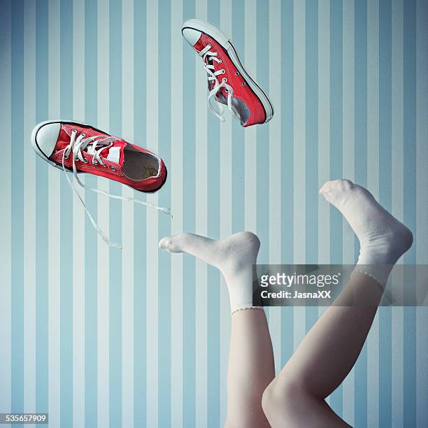woman with her legs in the air with trainers mid air - socks ストックフォトと画像