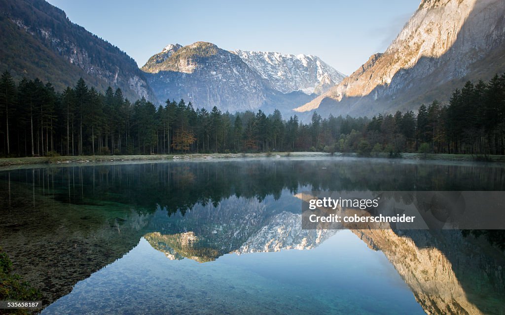 Austria, Salzburg, Mountains reflecting in mountain lake