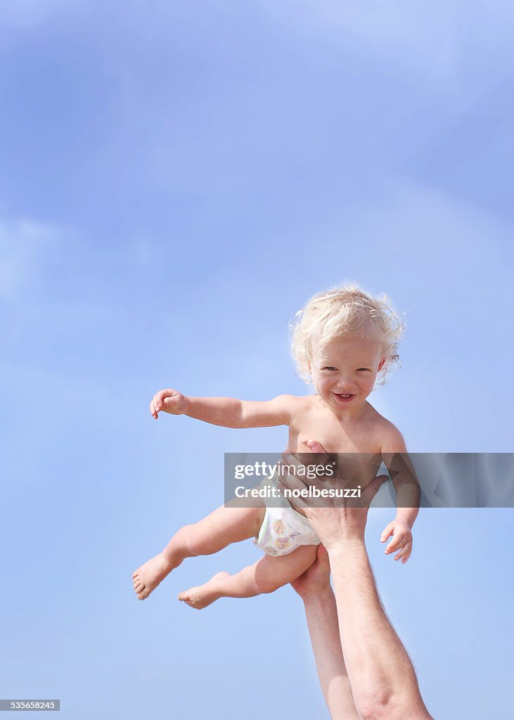 Toddler being lifted in air