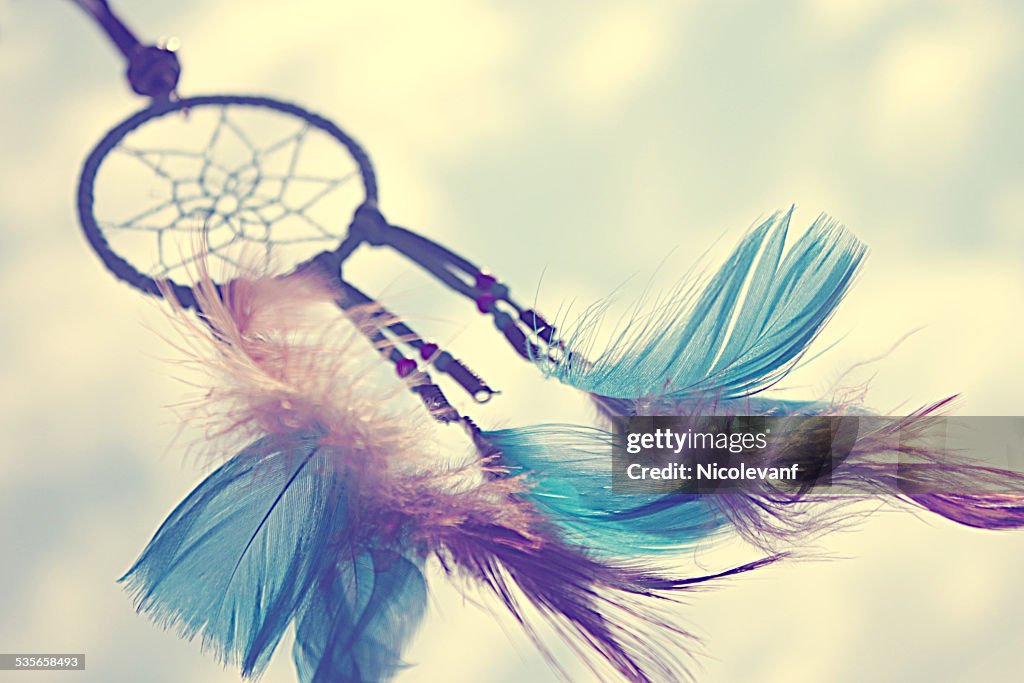 Close-up shot of dreamcatcher with colored feathers