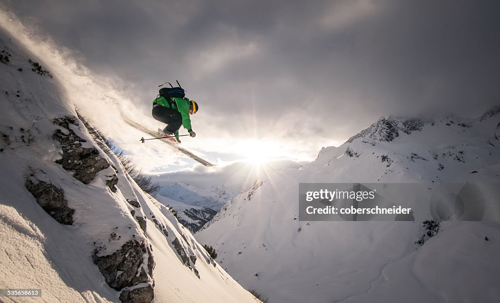 Austria, Freeride skier jumping off rock