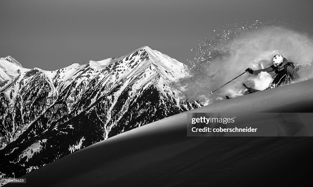 Austria, Front view of free ride skier downhill skiing