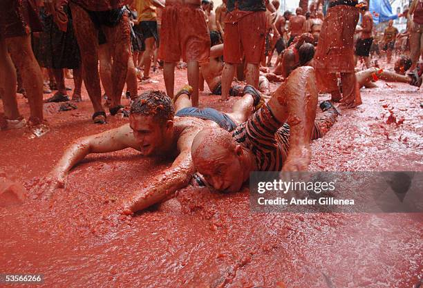 Two men trying to swim immersed in tomato juice during the Tomatina festival on August 31, 2005 in Bunyol, Valencia, Spain. Approximately 45,000...