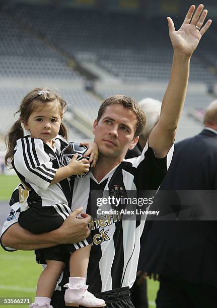 Newcastle United's new signing Michael Owen carries his daughter, Gemma, as he is introduced to the fans at St James' Park on August 31, 2005 in...