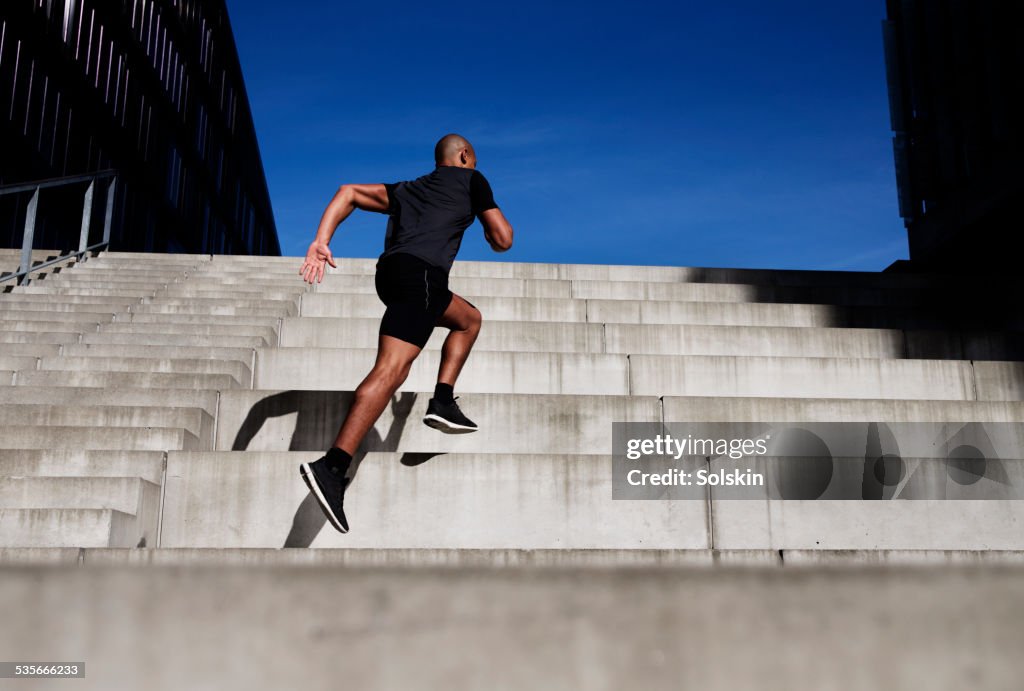 Man running up outdoor stairs