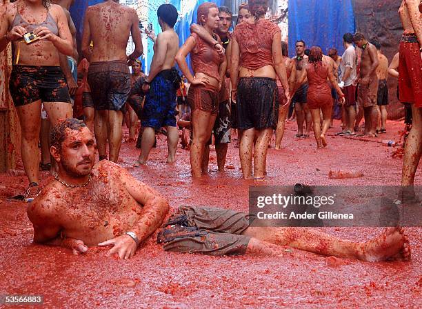 Person lies immersed in tomato juice in the 'Tomatina' on August 31, 2005 in Bunyol, Spain. The origins of the Tomatina are unknown, however fifty...