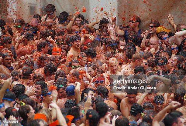 People throw tomatoes during the 'Tomatina' on August 31, 2005 in Bunyol, Spain. The origins of the Tomatina are unknown, however fifty years on and...