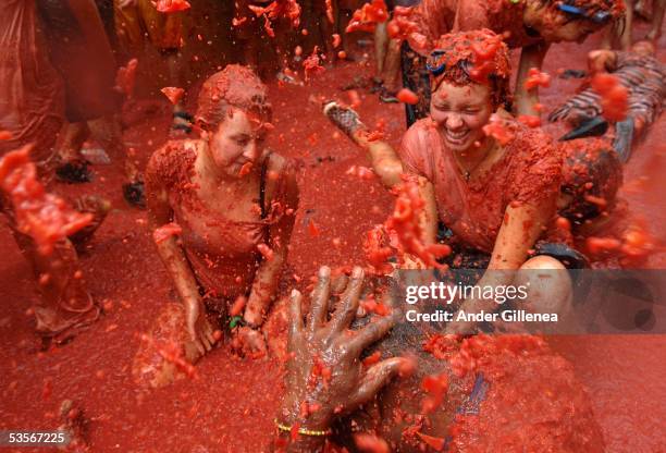 People immersed in tomato juice during the Tomatina on August 31, 2005 in Bunyol, Valencia, Spain. The origins of the Tomatina are unknown, however...