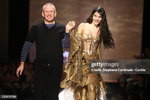 French designer Jean-Paul Gaultier walks on the catwalk with a model at the end of his Haute-Couture Spring/Summer 2008 Haute Couture fashion show in...