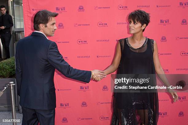 Olivier Martinez and Halle Berry attend the 'Toiles Enchantees' Red Carpet as part of the Champs Elysees Film Festival 2013 at Publicis Champs...