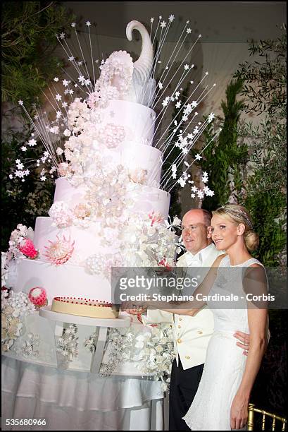 Prince Albert II of Monaco and Princess Charlene of Monaco cut the wedding cake during the dinner at Opera terraces, after the religious wedding...