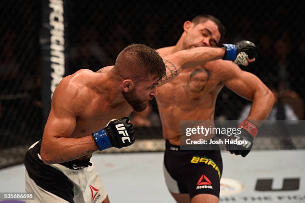 Jeremy Stephens punches Renan Barao of Brazil in their featherweight bout during the UFC Fight Night event inside the Mandalay Bay Events Center on...