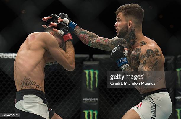 Cody Garbrandt punches Thomas Almeida in their bantamweight bout during the UFC Fight Night event inside the Mandalay Bay Events Center on May 29,...
