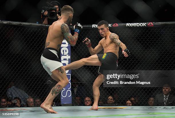 Thomas Almeida kicks Cody Garbrandt in their bantamweight bout during the UFC Fight Night event inside the Mandalay Bay Events Center on May 29, 2016...