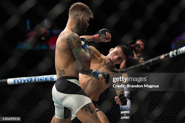 Cody Garbrandt punches Thomas Almeida in their bantamweight bout during the UFC Fight Night event inside the Mandalay Bay Events Center on May 29,...