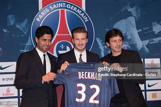 President of PSG Nasser Al-Khelaifi, International soccer player David Beckham and PSG director of football Leonardo pose with the PSG Football shirt...