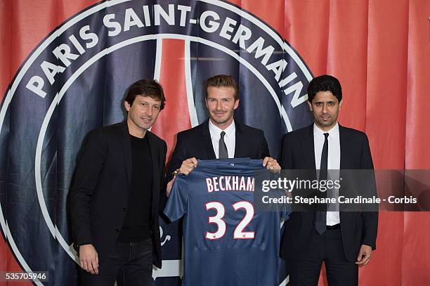 Director of football Leonardo, International soccer player David Beckham and president of PSG Nasser Al-Khelaifi pose with the PSG Football shirt...