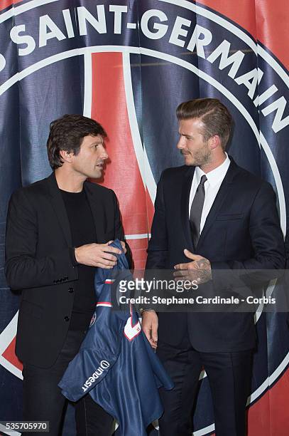 Director of football Leonardo and International soccer player David Beckham pose after Beckham PSG signature at Parc des Princes , in Paris.