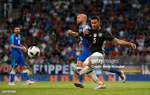 Jonas Hector of Germany is challenged by Miroslav Stoch of Slovakia during the International Friendly match between Germany and Slovakia at WWK-Arena...