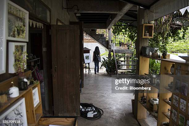 Shopper walks through the Bann Kang Wat artists' village market in Chiang Mai, Thailand, on Sunday, May 29, 2016. Thailand's gross domestic product...