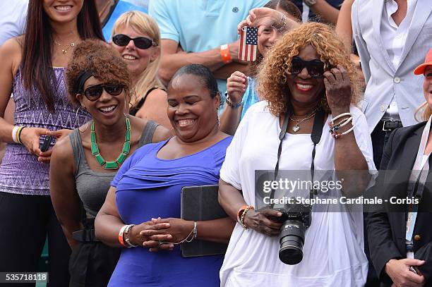 Venus Williams, Isha Price and Oracene Price the mother of Serena Williams of United States of America looks on after her Women's singles final match...