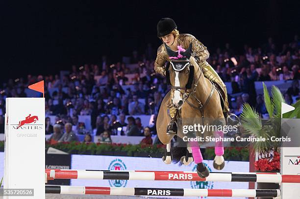 Electra Niarchos rides Lilli Marlen 18 during the Style & Competition for Amade at the Gucci Paris Masters 2013, in Paris.