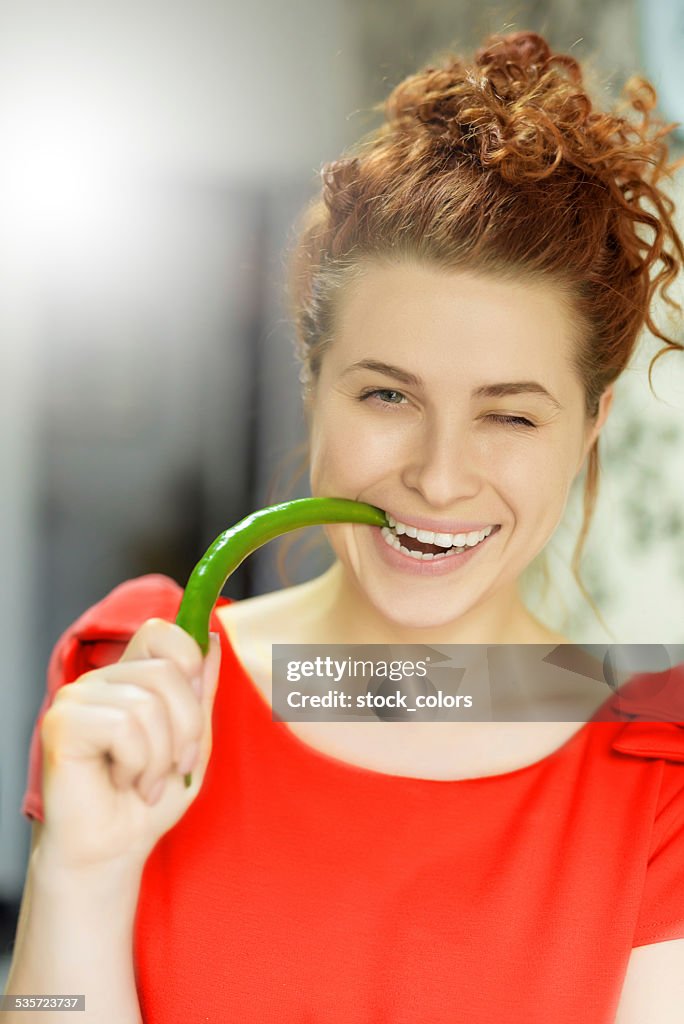 Winking woman with jalapeno pepper