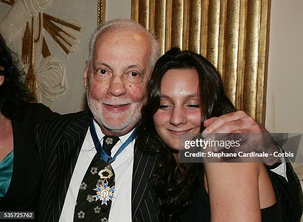 Actor Michel Serrault and his granddaughter Gwendoline celebrate the presentation of the "Chevalier de l'Ordre National du Merite" award to the...