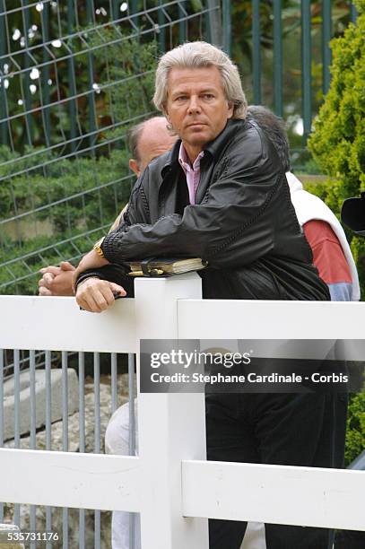 Thierry Roussel watches his daughter Athina as she trains.