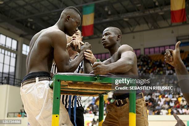 Arm wrestlers compete at the International Arm Wrestling Championship in Bamako on May 29, 2016.The first edition of the International Arm Wrestling...