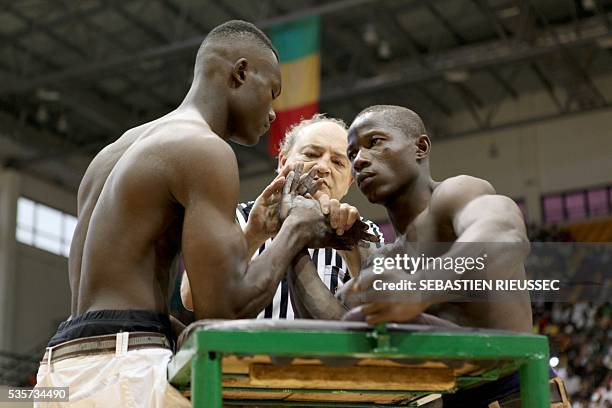 Arm wrestlers compete at the International Arm Wrestling Championship in Bamako on May 29, 2016.The first edition of the International Arm Wrestling...