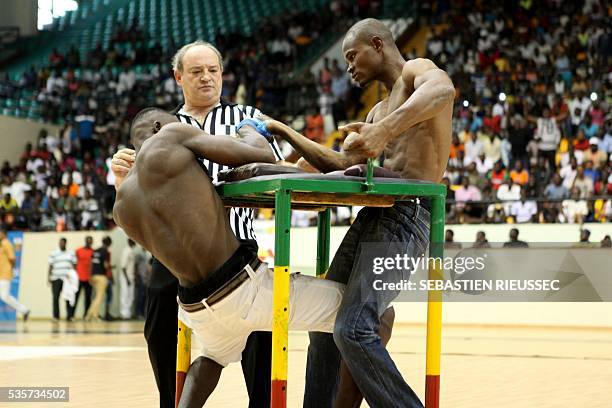 Arm wrestlers compete at the International Arm Wrestling Championship in Bamako on May 29, 2016.The first edition of the International Arm Wrestling...