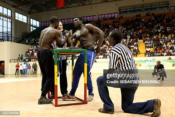 Arm wrestlers compete at the International Arm Wrestling Championship in Bamako on May 29, 2016.The first edition of the International Arm Wrestling...