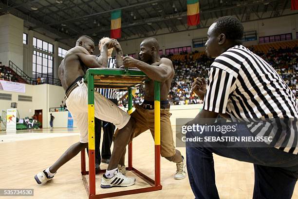 Arm wrestlers compete at the International Arm Wrestling Championship in Bamako on May 29, 2016.The first edition of the International Arm Wrestling...