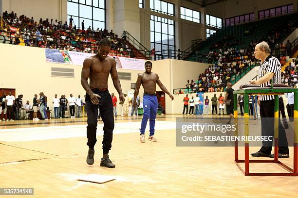 Arm wrestlers arrive to compete at the International Arm Wrestling Championship in Bamako on May 29, 2016.The first edition of the International Arm...