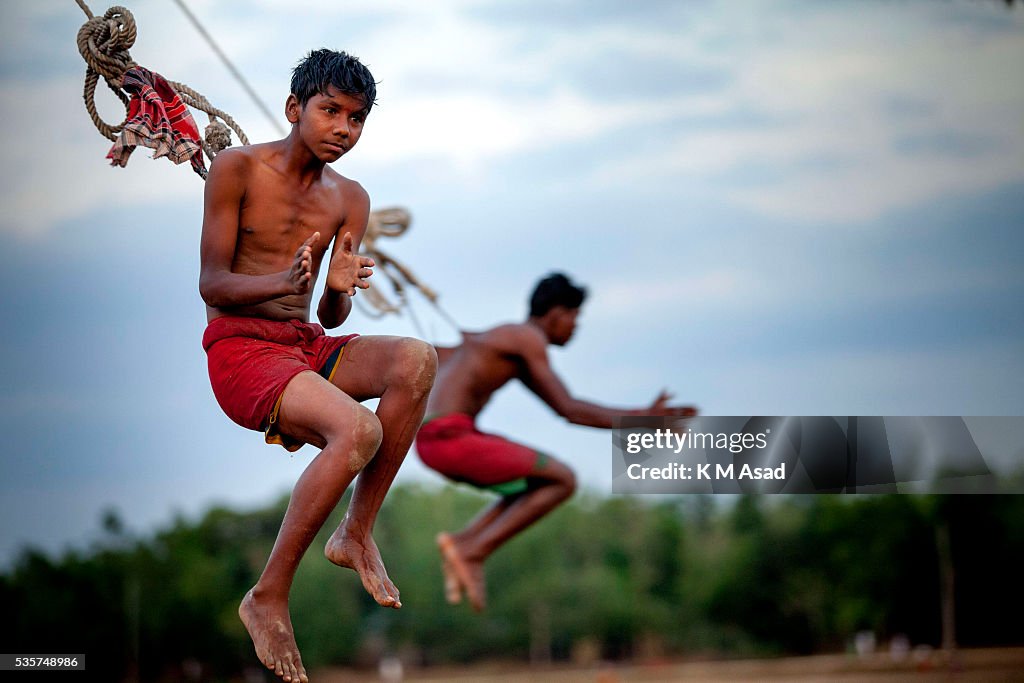 An ascetic devotee hangs from a spinning wheel attached with...
