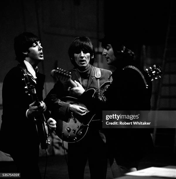 English pop group The Beatles Rehearsing at the Donmar Warehouse theatre, London, 1964. Left to right: Paul McCartney, George Harrison and John...