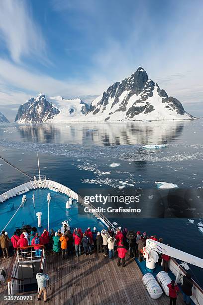 antartica tourists on ship driving through lemaire channel - antarctica boat stock pictures, royalty-free photos & images