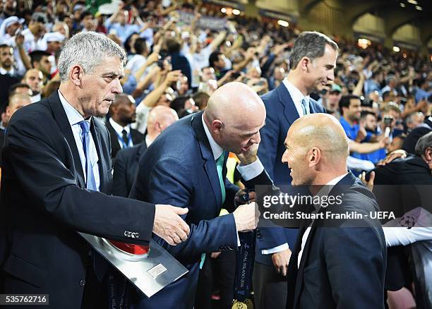 Zinédine Zidane, head coach of Madrid is congratulated by Gianni Infantino, FIFA President and Ángel María Villar Llona, first vice president of UEFA...