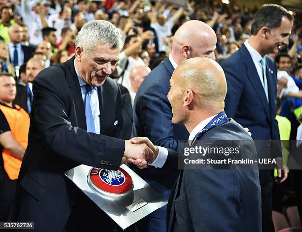 Zinédine Zidane, head coach of Madrid is congratulated by Ángel María Villar Llona, first vice president of UEFA after the UEFA Champions League...