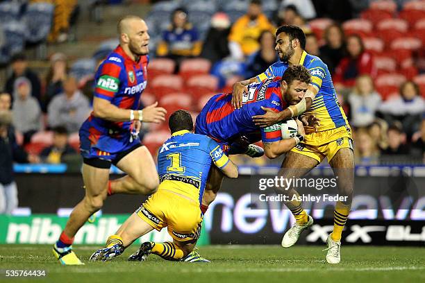 Korbin Sims of the Knights is tackled by the Eels defence during the round 12 NRL match between the Newcastle Knights and the Parramatta Eels at...